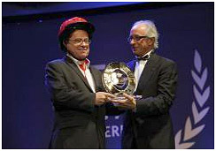 Greig Craft accepts the FIM’s Road Safety Award on behalf of the Global Helmet Vaccine Initiative