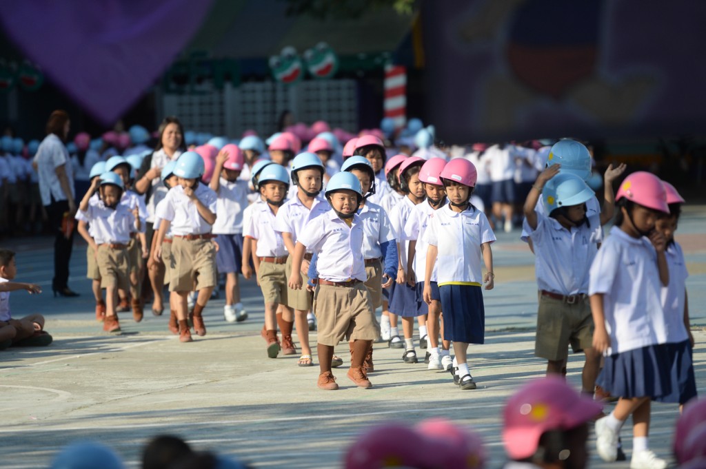 Students with their new helmets under the Helmets for Kids program supported by DENSO