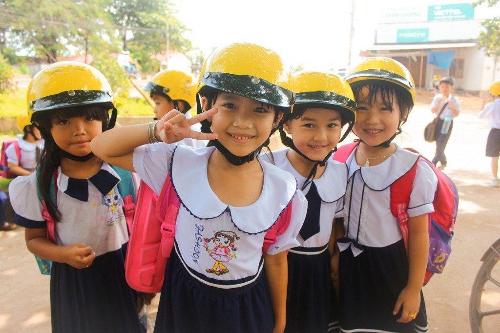 Students at a helmet donation ceremony in Dong Nai Province organized by AIP Foundation