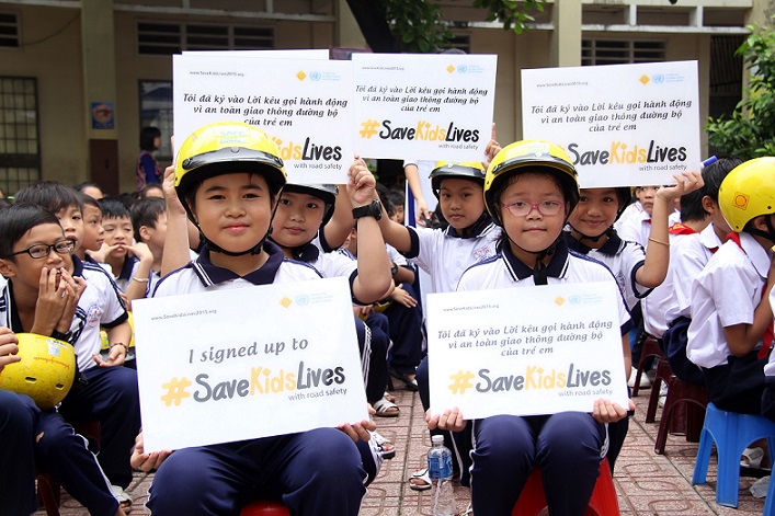 Children receive helmets donated by Johnson & Johnson