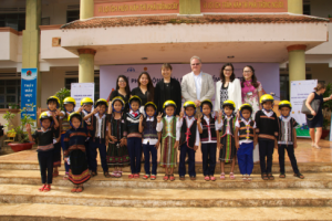 Sandra Lee and Gabriel Kardos (center) of Johnson & Johnson join AIP Foundation staff and students of Ia Ninh Primary School to celebrate the kick-off of the 2016 Helmets for Kids program in Gia Lai Province. 