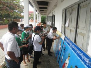 Manulife employees and AIP Foundation staff paint murals that highlight the importance of helmet wearing.