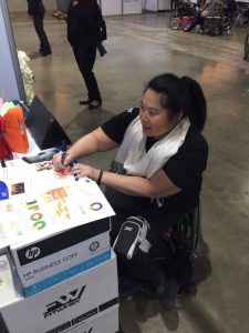 A conference attendee learns about AIP Foundation's Street Wise program, supported by Chevron.