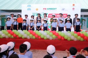 Students at Nguyen Van The Elementary School demonstrating their brand new helmets onstage. 