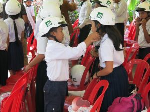 Schoolchildren at Kessararam Primary School in Siem Reap helping each others out with their new helmets.
