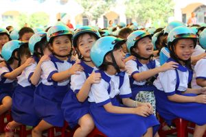 Students from Tan PhuTrung Primary School in the Cu Chi District of Ho Chi Minh City participate in the Helmets for Families road safety festival. 