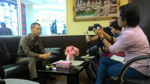 Pol. Lt. Colonel Dr. Panupong Panudulkitti, Inspector of the Traffic Police Division and LDP member, is interviewed by journalists.