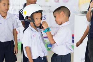Students demonstrating proper helmet wearing.